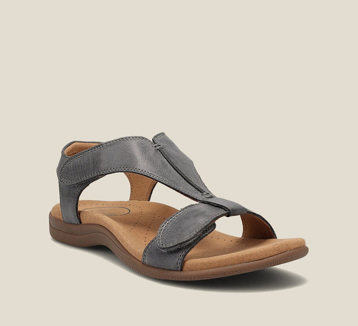 Grey orthopedic vegan leather sandal with open toe, wide strap, and cushioned sole.