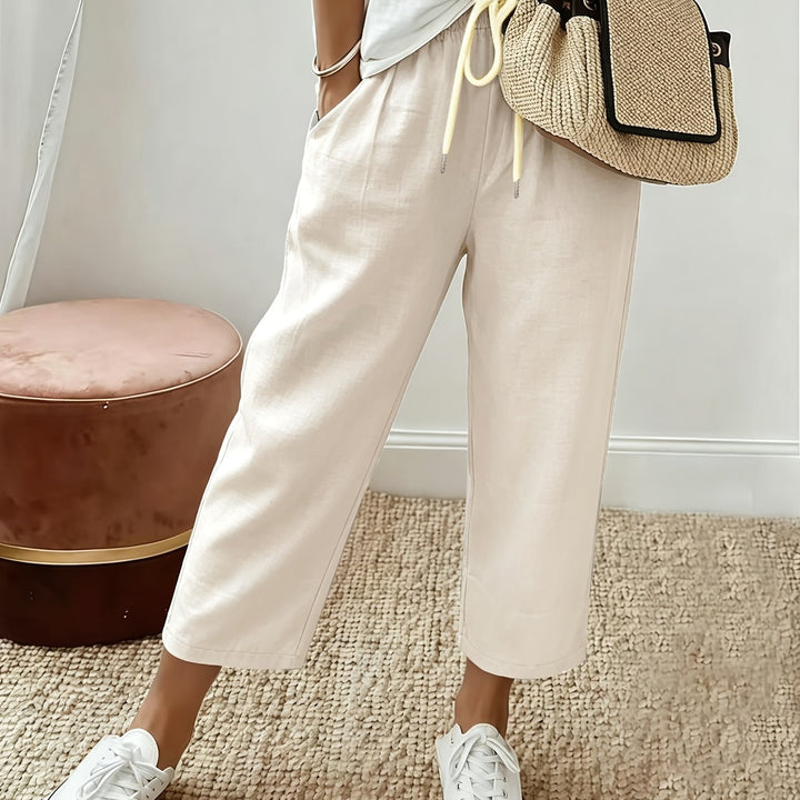 Cream cropped wide-leg trousers with drawstring waist and ankle-length hem