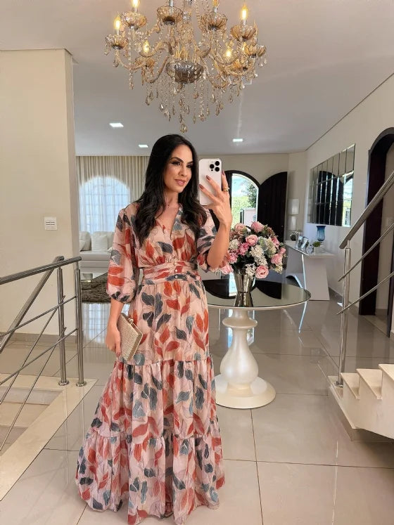 Pink floral tiered maxi dress with three-quarter sleeves and waist belt