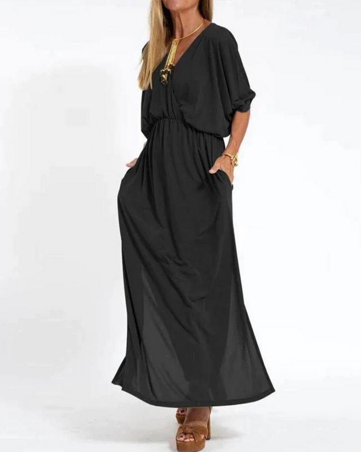 Black bohemian summer dress with V-neck, elastic waist, and flowy maxi skirt