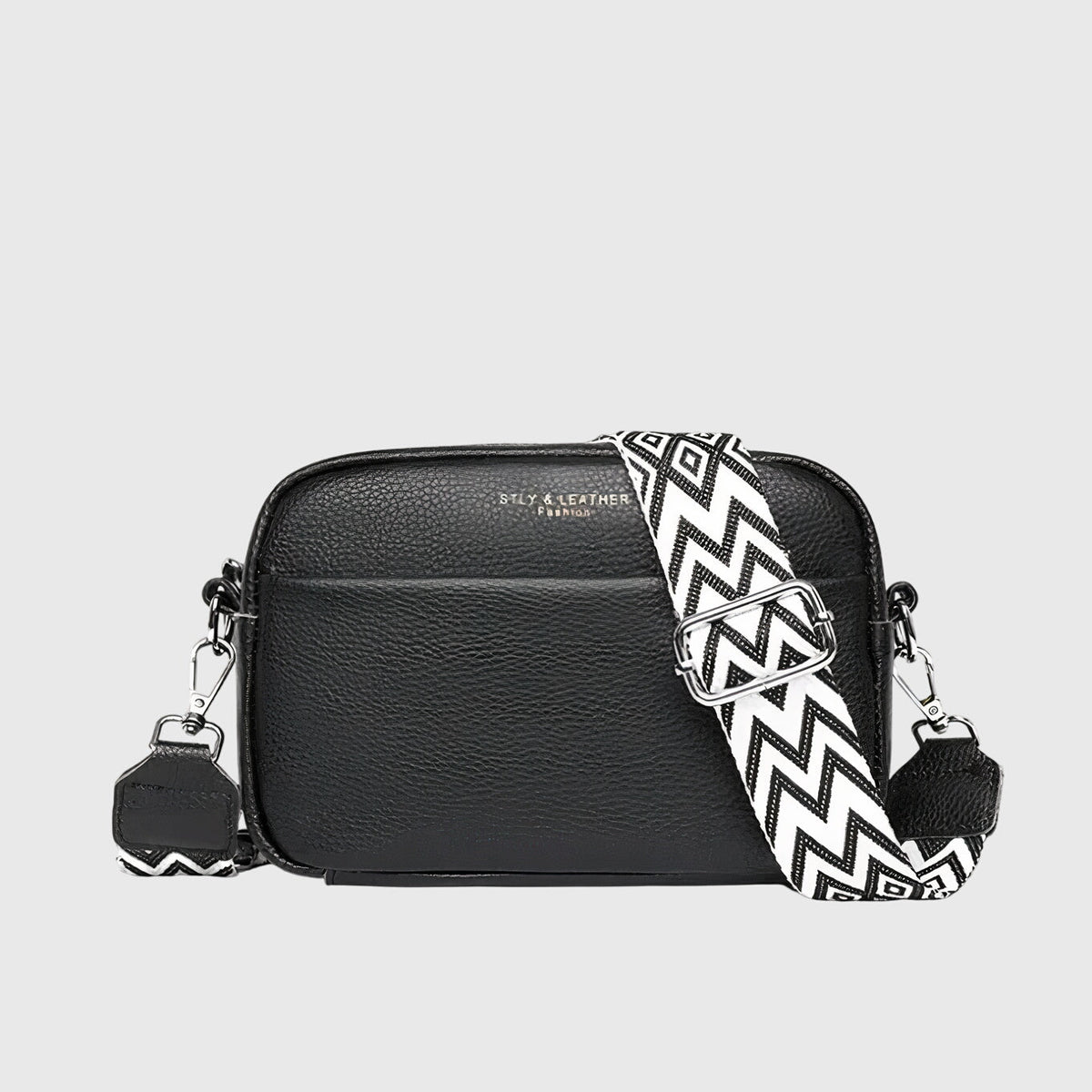 Black leather shoulder bag with chevron strap and two side zip pull charms