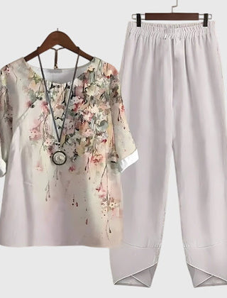 Two-piece set: white short-sleeve top and matching pants, pink floral splash design