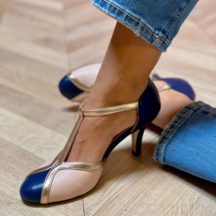 Dark blue heeled pump with ankle strap, metallic trim, and slim stiletto heel