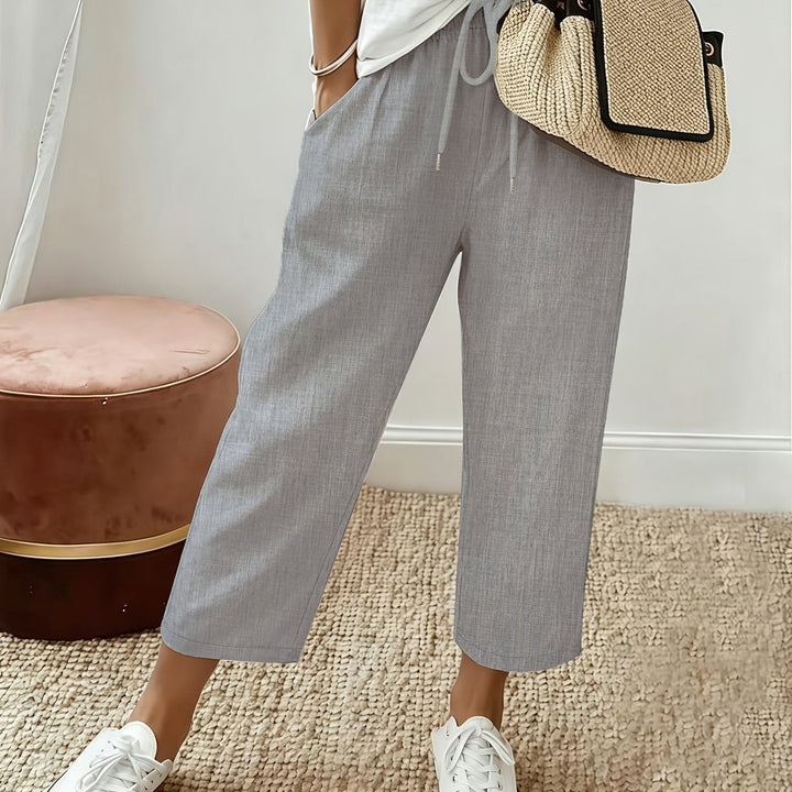 Grey cropped wide-leg trousers with drawstring waist and ankle-length hem