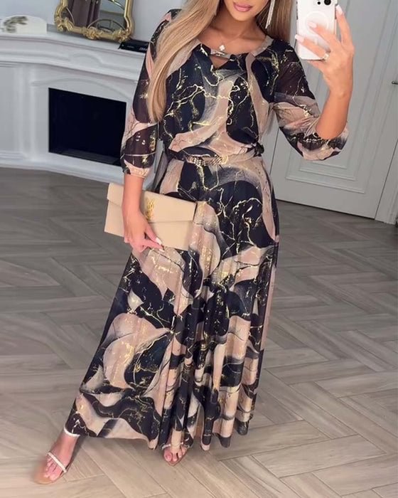 Chiffon maxi dress with navy and gold abstract print, three-quarter sleeves, ruffled neckline