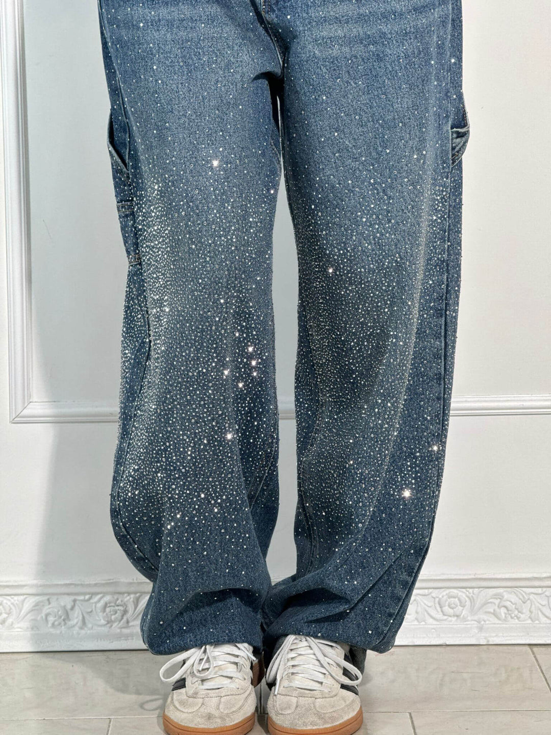 Dark indigo speckled wide-leg denim trousers, front fly and seam details close-up