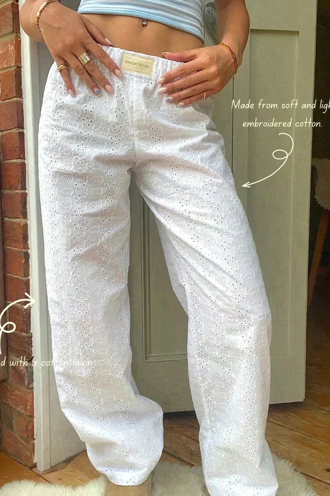 White lounge trousers with embroidered eyelet pattern and elastic drawstring waist