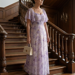 Floral lilac midi dress with flutter sleeves, ruched bodice, and soft pleated skirt
