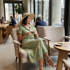 Green printed button-front belted midi dress seated, short sleeves and V-neck