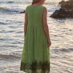 Green sleeveless midi dress back view with floral embroidery and softly gathered hem