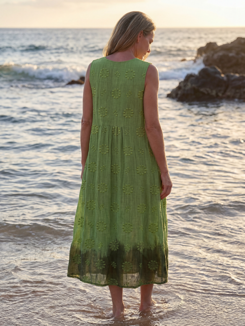 Green sleeveless midi dress back view with floral embroidery and softly gathered hem