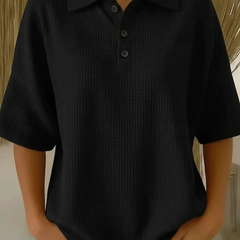 Black waffle knit polo blouse with short sleeves, pointed collar, three-button placket