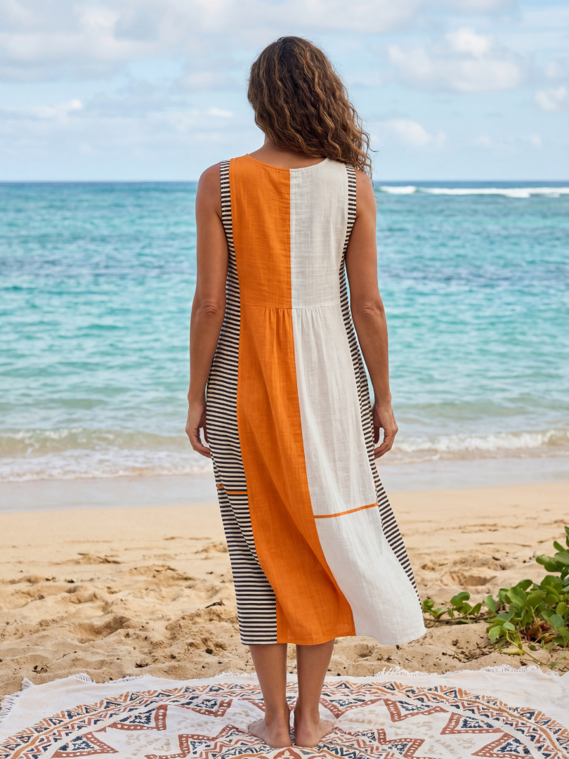 Back view of color-block striped midi dress with orange panel and striped side hem