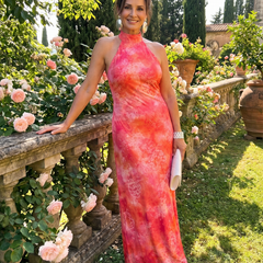 Orange halter neck maxi dress with pink patterned abstract print, long flowing hem