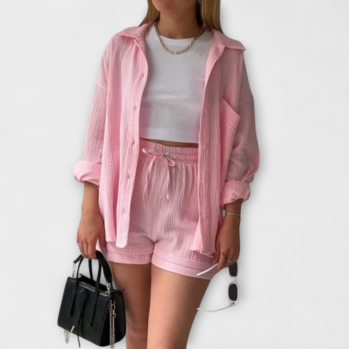 Pink lightweight top and shorts set with drawstring waist and ruffle trim