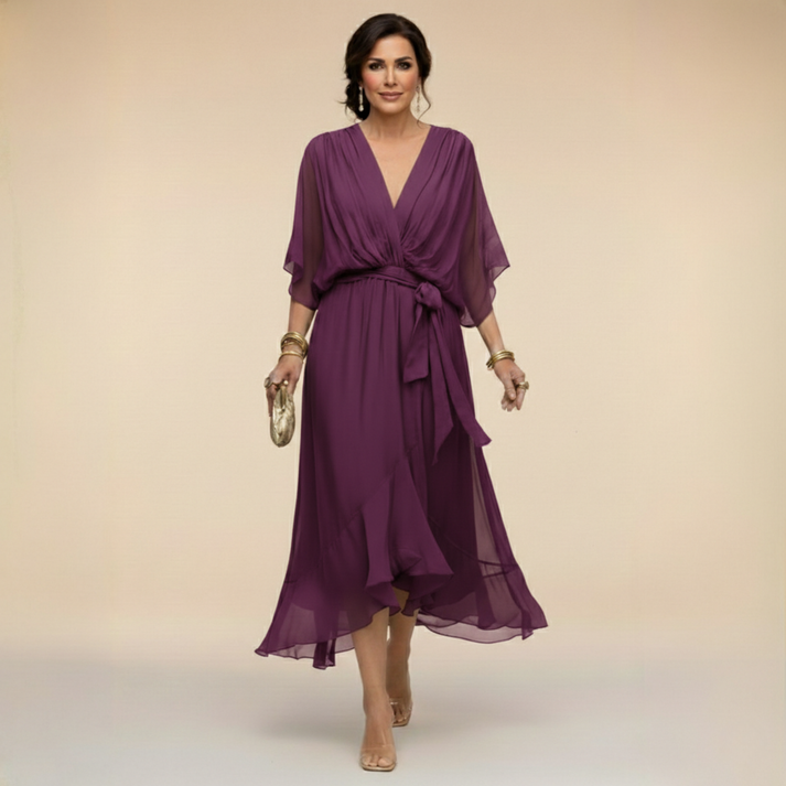 Purple V-neck wrap dress with tied waist and flowing chiffon mid-calf hem