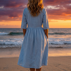 Light blue midi dress back view with gathered waist and three-quarter sleeves