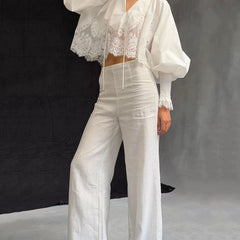 White lace blouse with V-neck, long puff sleeves, and embroidered lace center panel