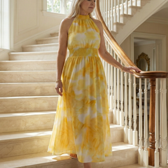 Yellow tie-dye gathered halter midi dress with ruched bodice and airy skirt.