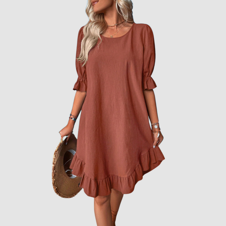 Rust flowy summer dress with half sleeves and gathered ruffle hem.