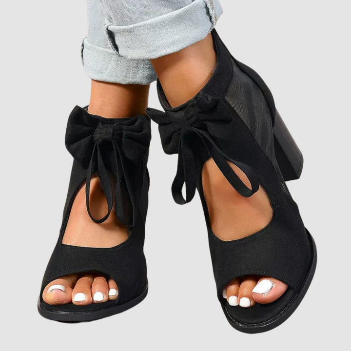Women's orthopedic black bow heels with mesh side cutout and peep toe, block heel
