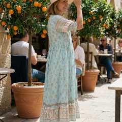 Light blue boho tiered midi dress with short puff sleeves and floral print