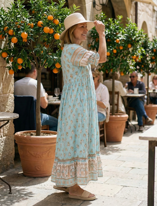 Light blue boho tiered midi dress with short puff sleeves and floral print