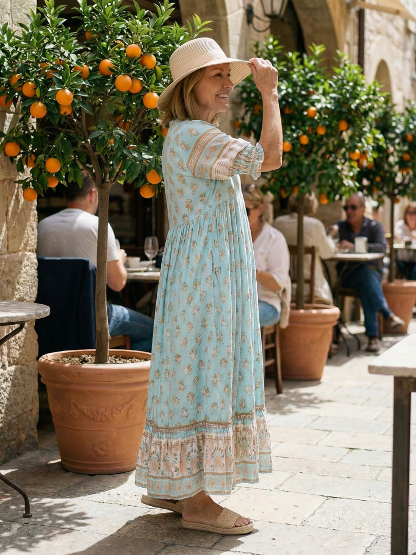 Light blue boho tiered midi dress with short puff sleeves and floral print