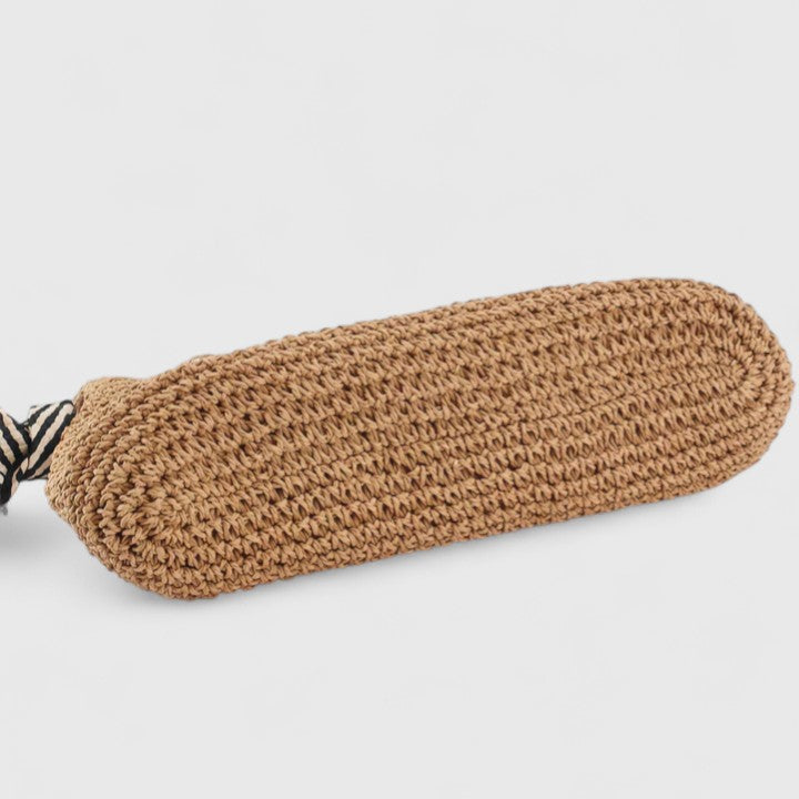 Warm brown woven boho bag with striped handle tie ends on the side