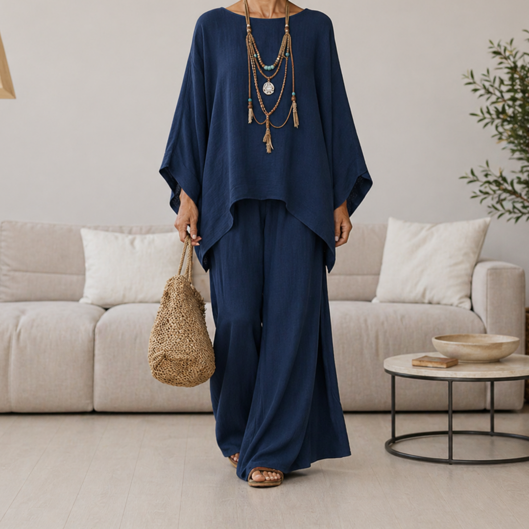 Navy two-piece set with draped tunic top and wide-leg pants, long sleeves.