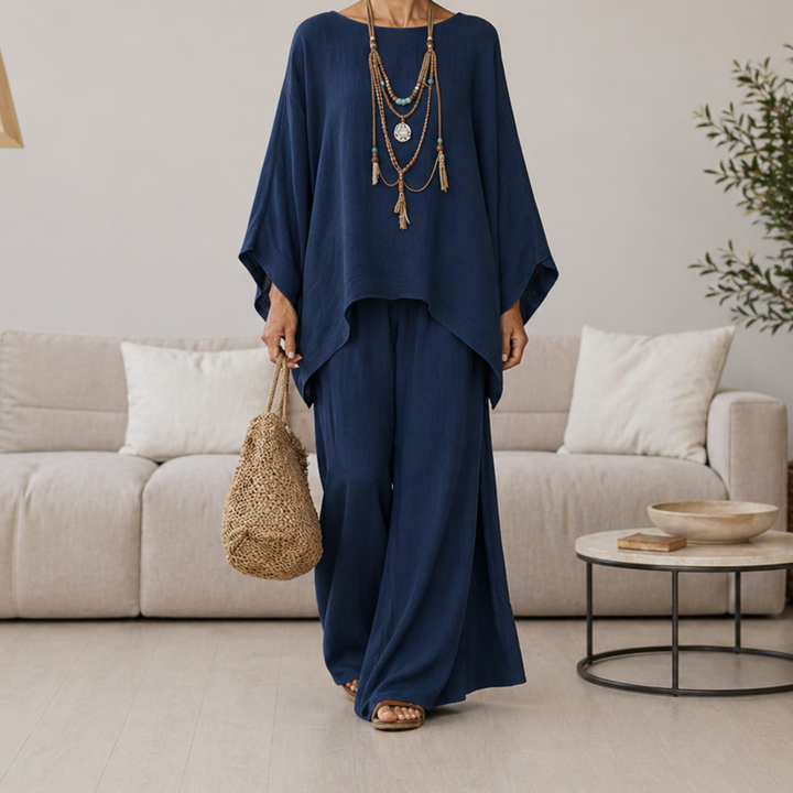 Navy two-piece set with draped tunic top and wide-leg pants, long sleeves.