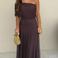 Dark plum strapless-style maxi dress with off-shoulder neckline and gathered skirt