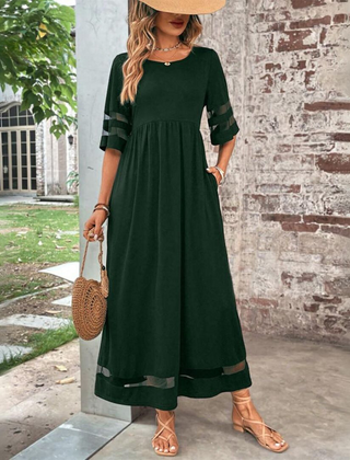 Green midi dress with gathered waist and elbow-length contrast striped sleeves.