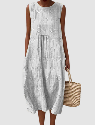White sleeveless midi dress with embroidered eyelet clover pattern, tiered skirt