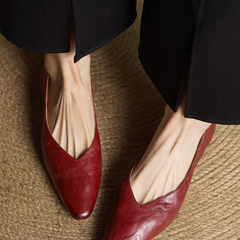 Maroon leather pointed-toe mules with low heel, slip-on design and V-cut opening