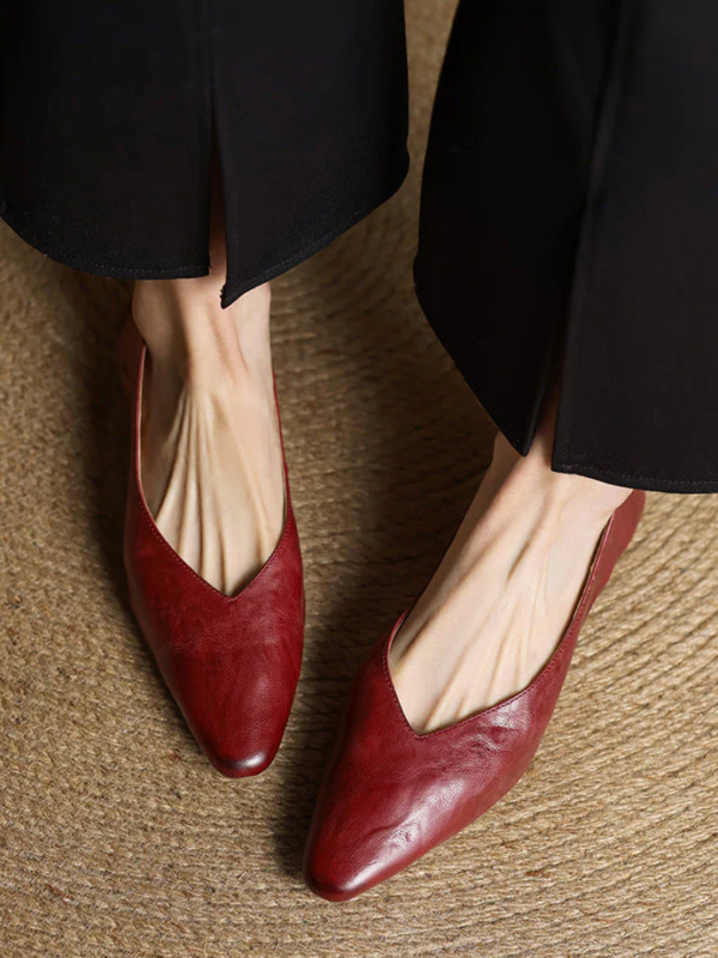 Maroon leather pointed-toe mules with low heel, slip-on design and V-cut opening