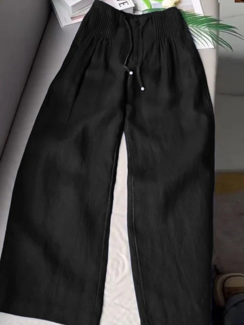 Black wide-leg trousers with elastic waistband, drawstring, and front button