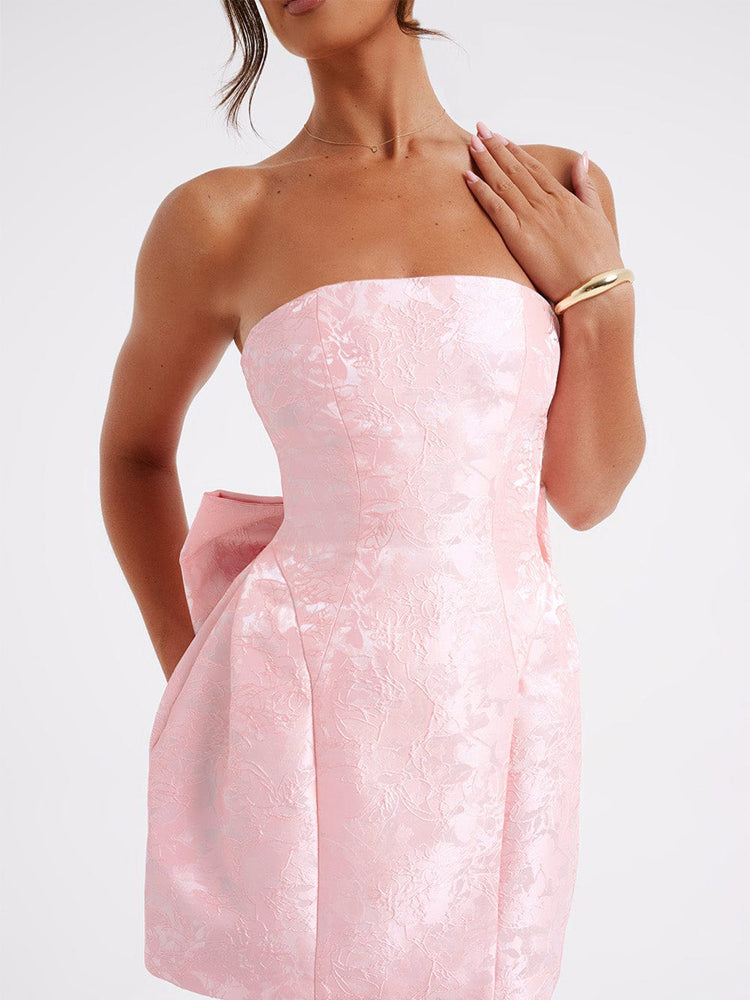 Pink strapless jacquard mini dress with sweetheart shape and waist bow-knot detail