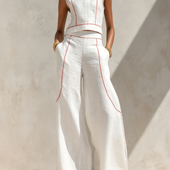 White wide-leg two-piece set with sleeveless top, red piping, and flowy pants