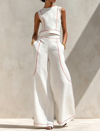 White wide-leg two-piece set with sleeveless top, red piping, and flowy pants