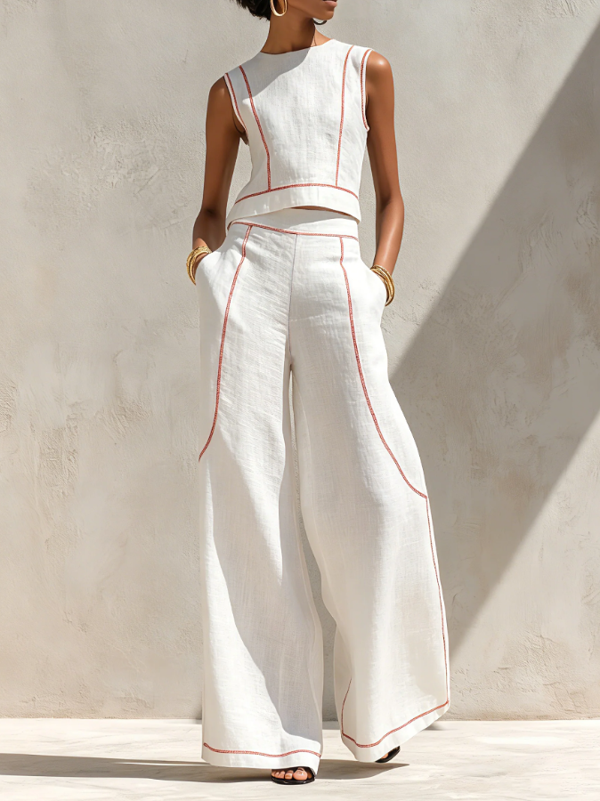 White wide-leg two-piece set with sleeveless top, red piping, and flowy pants