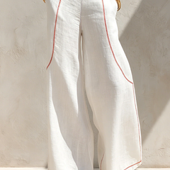 White wide-leg trousers from two-piece set with red piping, full-length view