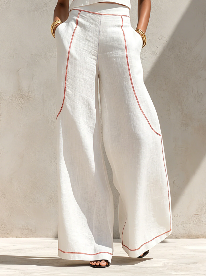 White wide-leg trousers from two-piece set with red piping, full-length view