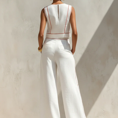 White sleeveless two-piece set, back view, red piping, wide-leg trousers