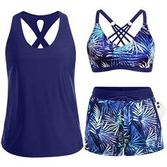 Navy tropical swim set with crisscross cutout tank, blue leaf-print bra, drawstring shorts