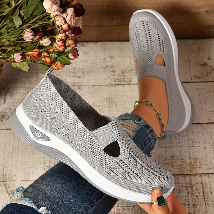 Light grey knit orthopedic slip-on shoes with oval cutouts and white sole