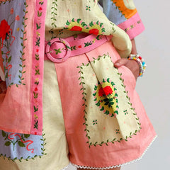 Patchwork shorts with pink belt tie, cream base and multicolor embroidered motifs