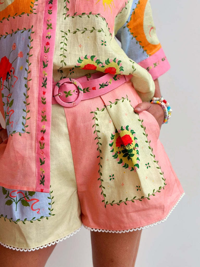 Patchwork shorts with pink belt tie, cream base and multicolor embroidered motifs