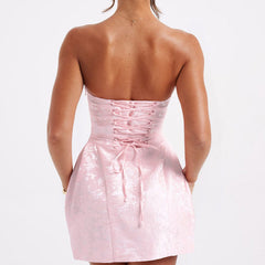 Pink jacquard mini dress back view with corset lacing across the bodice