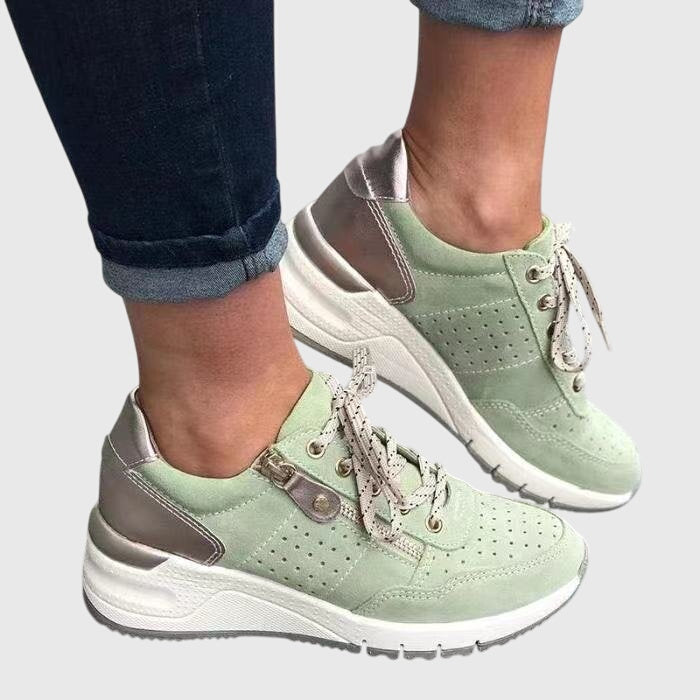 Light green orthopedic sneakers with lace-up, perforated uppers and padded collar